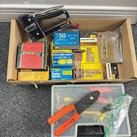 Box containing staple gun, staple boxes, hinges, barrel bolts