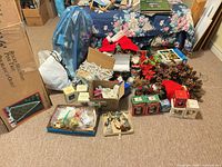 Overall view with boxed tree, ornaments, lights, wreath, figurines and storage items