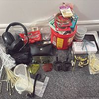 Entire lot showing goggles, earmuffs, sunglasses in case, replacement lenses, bucket of hardware, zip ties and hooks