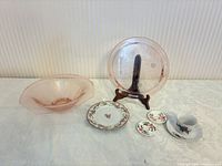 Group shot showing all items: cake plate on stand, bowl, dessert plate, candle rings, teacup & saucer