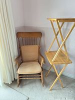 rocking chair beside two folding tables