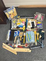 All items laid out showing variety of painting tools and accessories