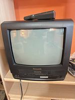 Front view of Panasonic CRT TV/VCR combo with remote on top