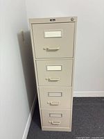 Front view of beige 4-drawer filing cabinet showing recessed handles and label holders