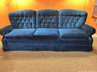 Full frontal view of the three-seat dark navy velvet sofa showing overall design and condition