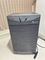 Front view of dehumidifier showing louvered grille and overall condition