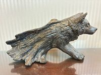 Left side profile of wolf sculpture showing texture and finish