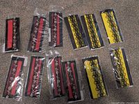 Assorted packaged chokers laid out, showing quantity and two design styles