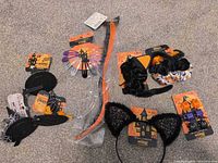 Overview of all packaged Halloween hair accessories on carpet