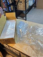 Box containing sealed bundles of poly bags and loose extras