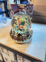 Oblique view of complete water globe with original Kirkland box behind