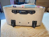 Bottom view showing two wheels, plastic handle mount, wear on corners