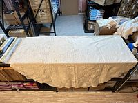 oval tablecloth spread over bench