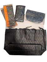 Top view showing tote purse, cosmetic pouch, tissue paper pack, additional sealed package