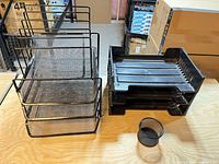 Overall lot showing metal mesh rack, three plastic trays stacked, mesh pencil cup