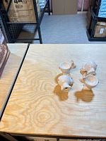 Four ceramic bunny egg cups on tabletop.