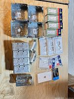 all items laid out: galvanized boxes, receptacles, switches, wall plates