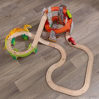 Full assembled layout showing wooden track loop, volcano spiral, Bronto bridge, grass inserts, red train car