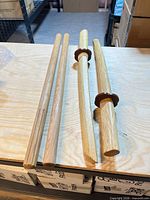 Two kali sticks and two bokken swords laid on table
