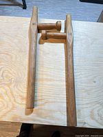 Pair of wooden tonfas laid flat showing full length and handles