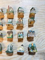 Front view of fifteen cottage thimbles displaying varied designs