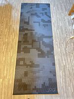Full view of Jogi black patterned yoga mat on floor