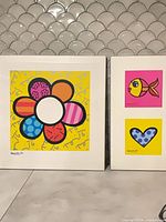 Overall shot of both framed Britto prints side by side