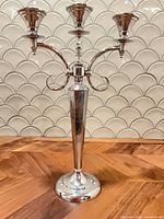 Front view of silver-tone three-arm candelabra
