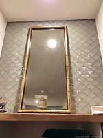 Full view of rectangular gold bamboo-style framed mirror