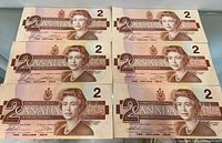 Front view of six Bank of Canada $2 notes showing Queen Elizabeth II portraits