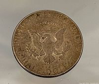 Reverse side showing presidential seal and HALF DOLLAR legend