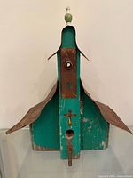 Front view showing entry hole, perch, cross detail, tin roof and finial