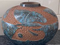 Front view showing carved butterfly design and glaze