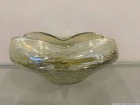 Angled view showing wavy rim and gold fleck inclusions