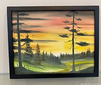 Front view of signed oil landscape painting in black frame