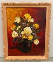 Front view of framed oil painting showing floral subject and frame