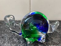 Side view of blue green clear glass turtle sculpture