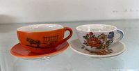 Front view of both teacups on saucers showing designs