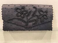 Front view showing bead floral motif and fringe