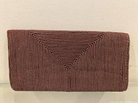 Front view of brown corded envelope clutch