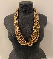 Full view of necklace on display bust showing strands and colour