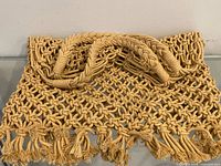 Top view highlighting braided handles and rope texture