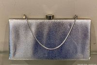 Front view of silver glitter purse with chain handle