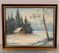 Front view of framed winter barn oil painting