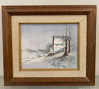 Front view of framed winter landscape painting