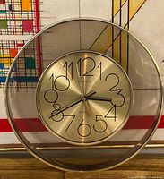 Front view showing complete clock, dial, numerals, lucite case