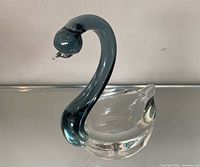 Side view of swan dish showing teal neck and clear bowl