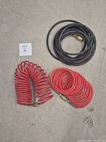 Top view showing all three air hoses: black straight, red coiled, red straight, with brass fittings.