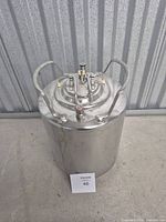 Top and side view of stainless steel ball-lock keg