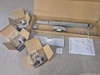 All items laid out: crash bar assembly, push plate, hardware, three boxed lever sets